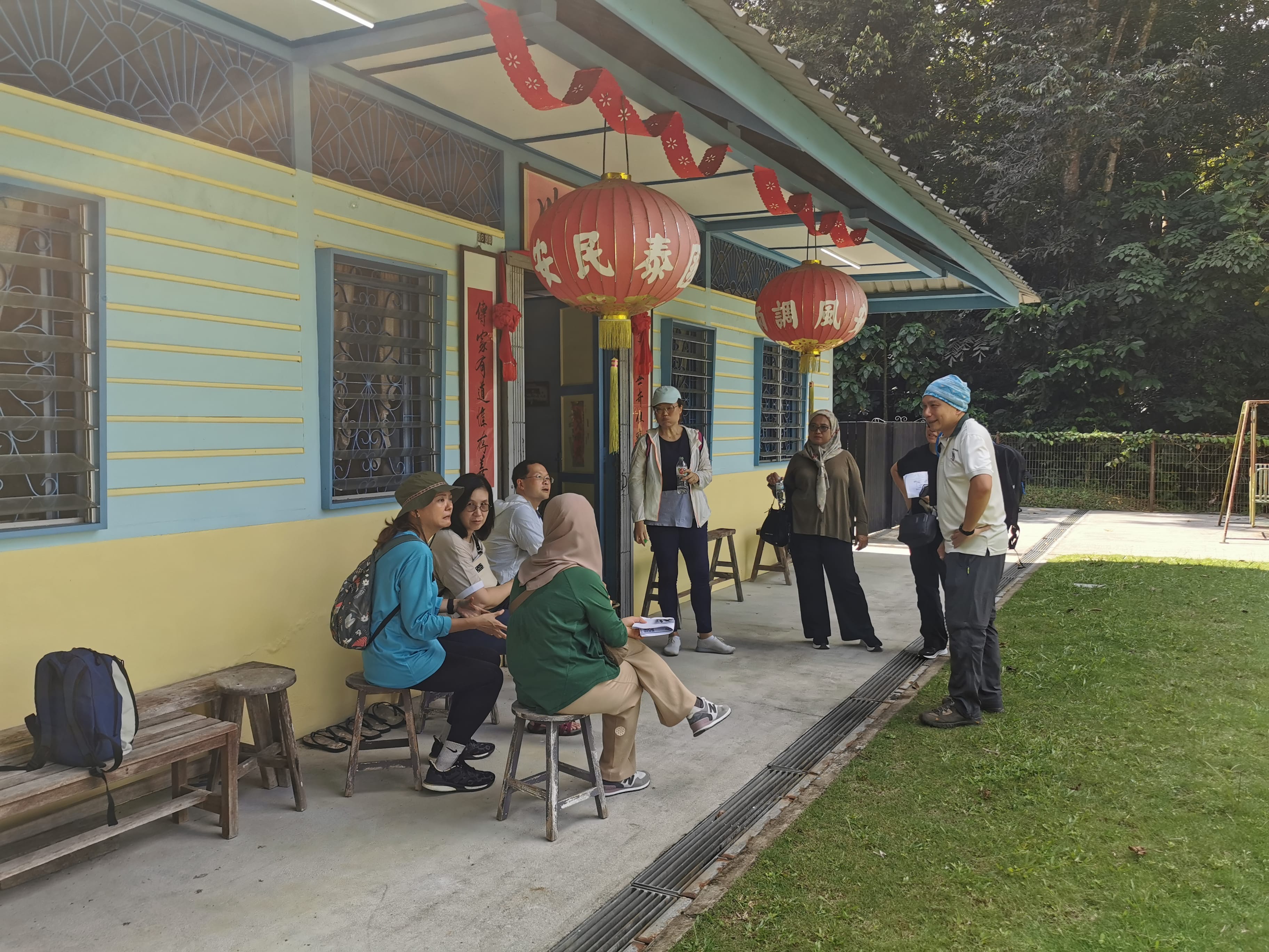 blue kampong house with guided trour partcipants outside